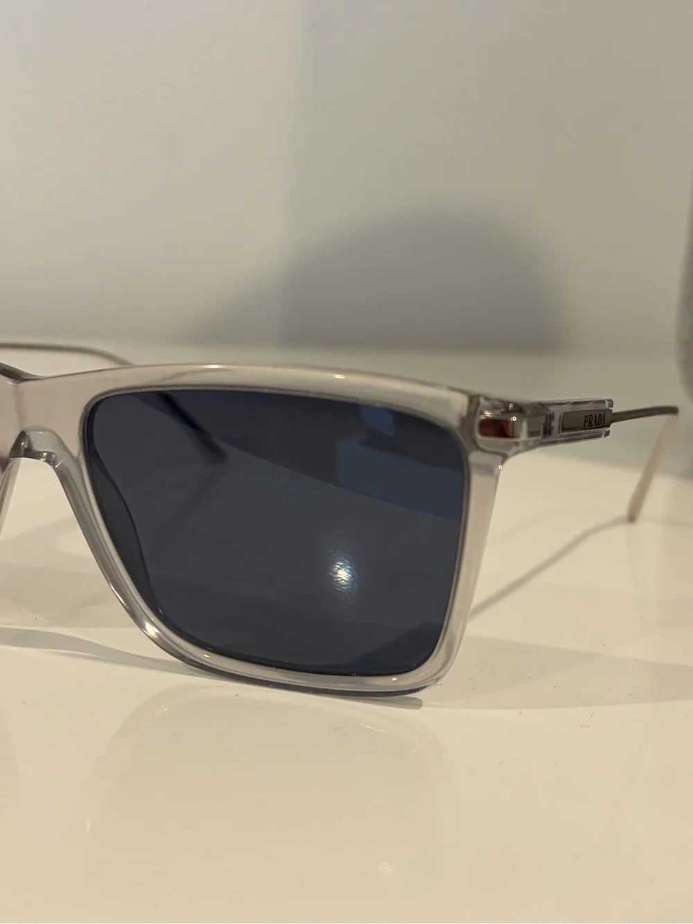Prada Men’s Clear Frame Sunglasses with Dark Blue Lenses
